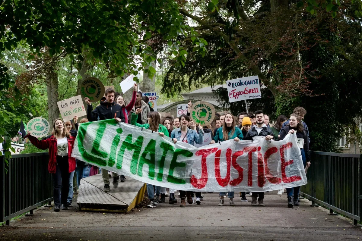 Crowd carrying a Climate Justice banner
